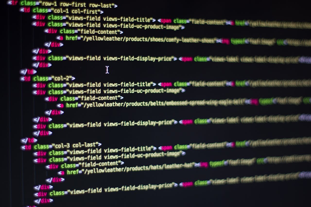 services-01 Detailed close-up of HTML code on a computer monitor, showcasing web development.